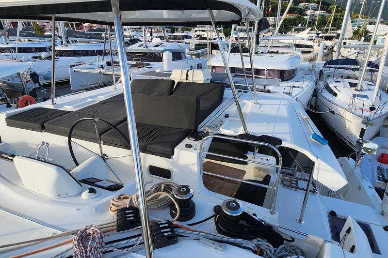 Clearlake III Yacht Photos Pics 2021 Lagoon 46 catamaran docked in a marina, featuring spacious deck and seating area.