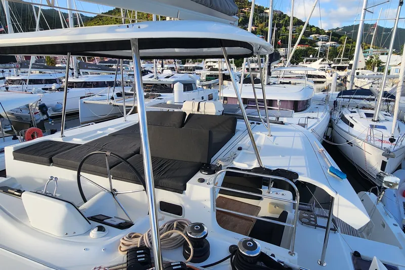 Clearlake III Yacht Photos Pics 2021 Lagoon 46 catamaran docked in a marina, featuring spacious deck and seating area.
