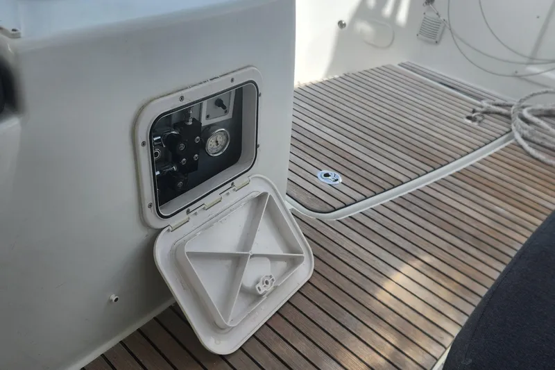 Clearlake III Yacht Photos Pics Open hatch on 2021 Lagoon 46 yacht, revealing mechanical components on teak deck.