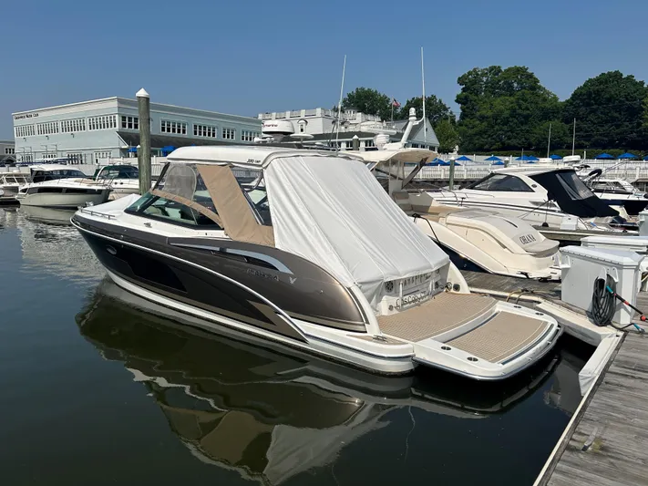  Yacht Photos Pics 2017 Formula 350 CBR boat docked at marina, featuring sleek design and covered seating area.