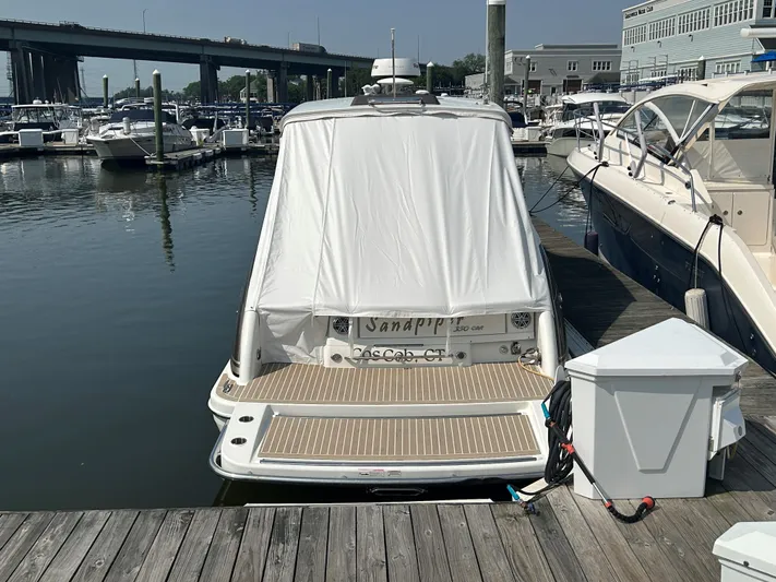  Yacht Photos Pics 2017 Formula 350 CBR boat docked, covered, with marina and bridge in background.