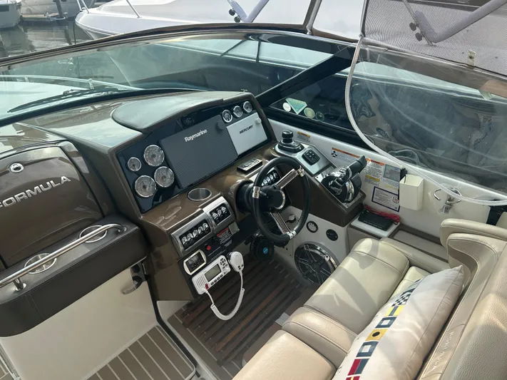  Yacht Photos Pics 2017 Formula 350 CBR boat cockpit with steering wheel, gauges, and navigation equipment.