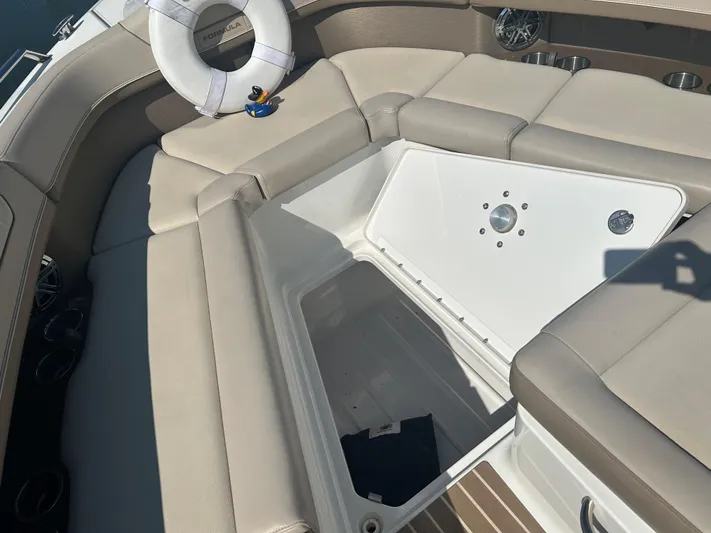  Yacht Photos Pics 2017 Formula 350 CBR boat interior with open storage compartment and life preserver.