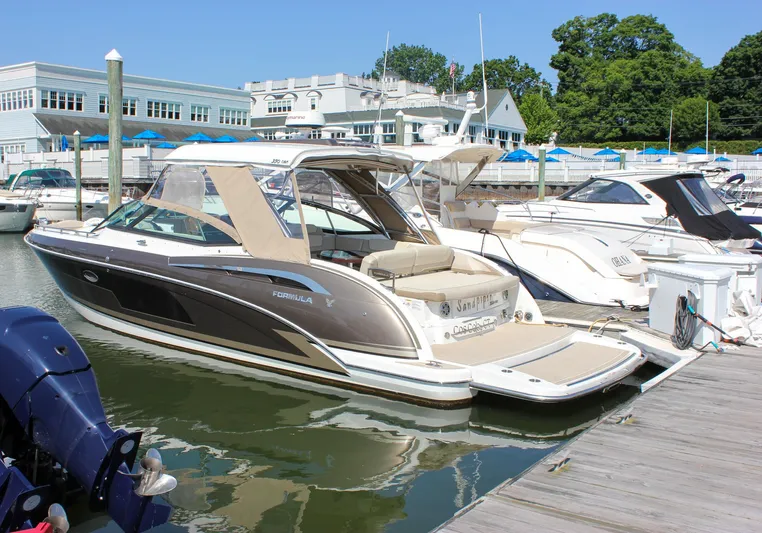  Yacht Photos Pics 2017 Formula 350 CBR boat docked at marina, surrounded by other boats and buildings.