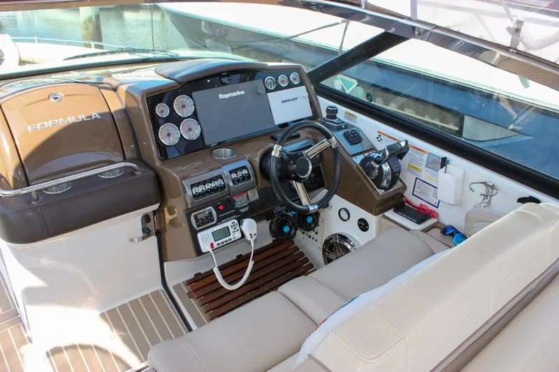  Yacht Photos Pics 2017 Formula 350 CBR boat cockpit with steering wheel, gauges, and navigation equipment.
