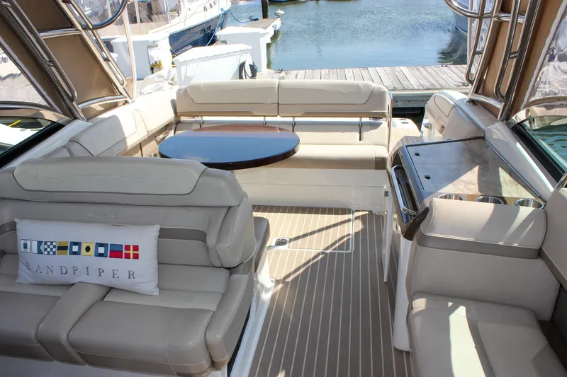  Yacht Photos Pics 2017 Formula 350 CBR boat interior with beige seating and a round table.