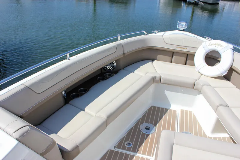  Yacht Photos Pics Luxurious seating area on a 2017 Formula 350 CBR boat, featuring beige upholstery and cup holders.