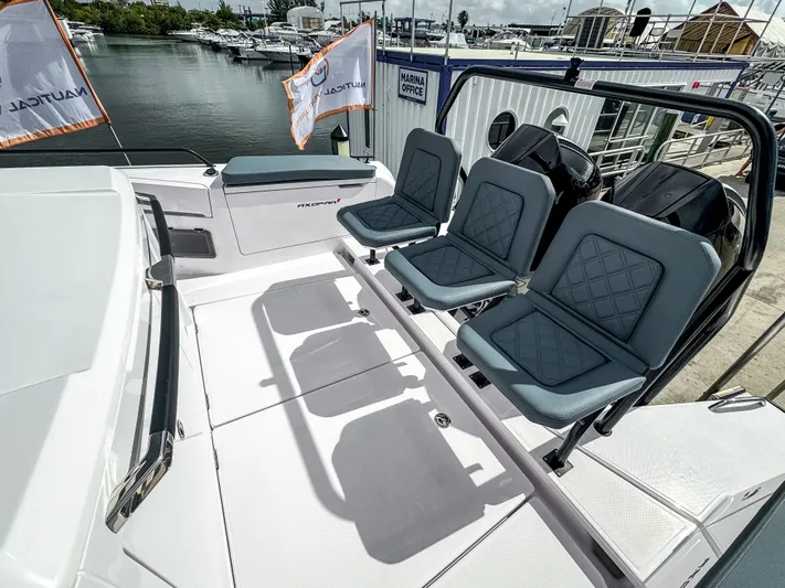  Yacht Photos Pics 2024 Axopar 37XC CROSS CABIN boat with stylish seating, docked at a marina.