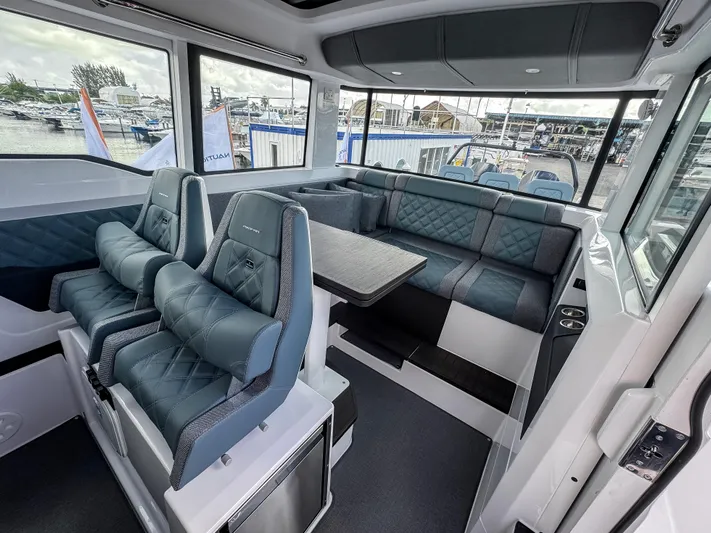  Yacht Photos Pics 2024 Axopar 37XC CROSS CABIN interior with luxurious seating and panoramic windows.