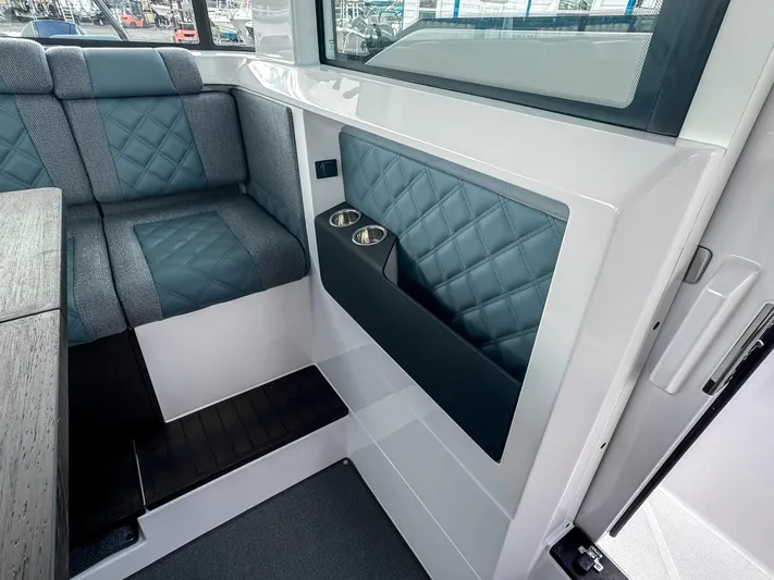  Yacht Photos Pics 2024 Axopar 37XC CROSS CABIN interior with quilted seating and cup holders.