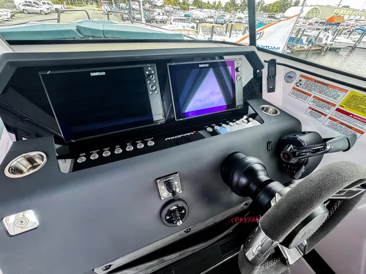  Yacht Photos Pics Control panel of 2024 Axopar 37XC CROSS CABIN with dual screens and steering wheel.