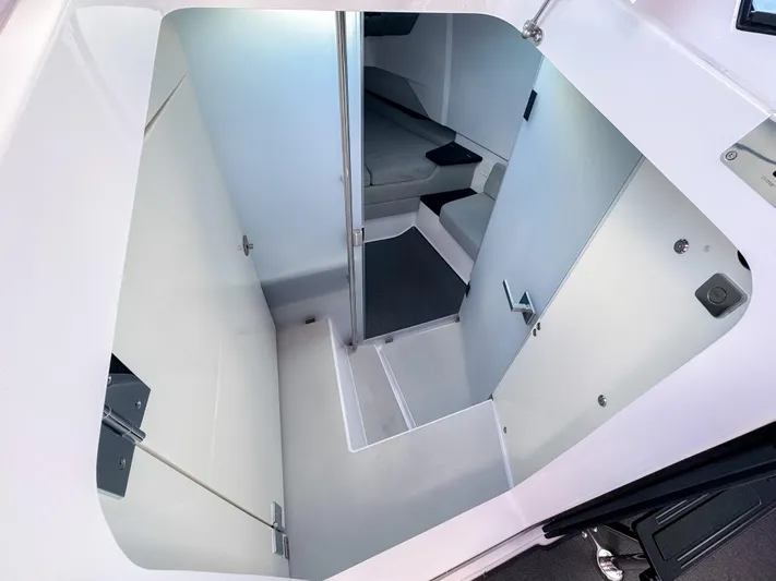  Yacht Photos Pics 2024 Axopar 37XC CROSS CABIN interior, featuring modern design and compact sleeping area.