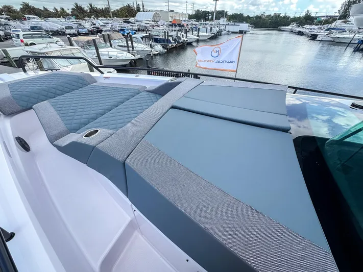  Yacht Photos Pics 2024 Axopar 37XC CROSS CABIN with sleek deck design at a marina.