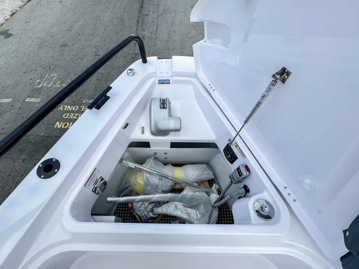  Yacht Photos Pics Storage compartment of 2024 Axopar 37XC CROSS CABIN boat, open with equipment inside.