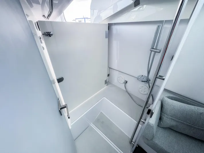  Yacht Photos Pics 2024 Axopar 37XC CROSS CABIN shower area with modern fixtures and sleek design.