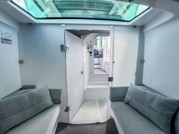  Yacht Photos Pics 2024 Axopar 37XC CROSS CABIN interior with skylight and modern seating.
