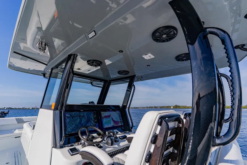  Yacht Photos Pics 2024 Costa Custom Boats 34SV helm with advanced navigation system on open water.