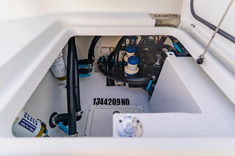  Yacht Photos Pics Engine compartment of 2024 Costa Custom Boats 34SV, showcasing mechanical components and wiring.