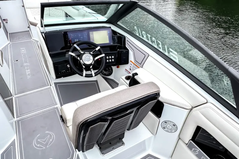 Yacht Photos Pics 2026 Ingenity EL boat cockpit with modern steering and digital controls on a serene water backdrop.