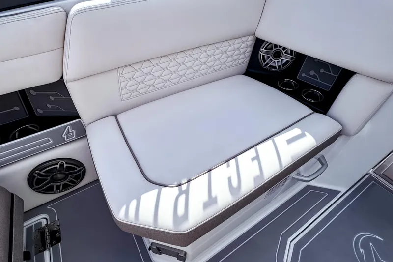  Yacht Photos Pics 2026 Ingenity EL boat interior with white cushioned seating and integrated speakers.