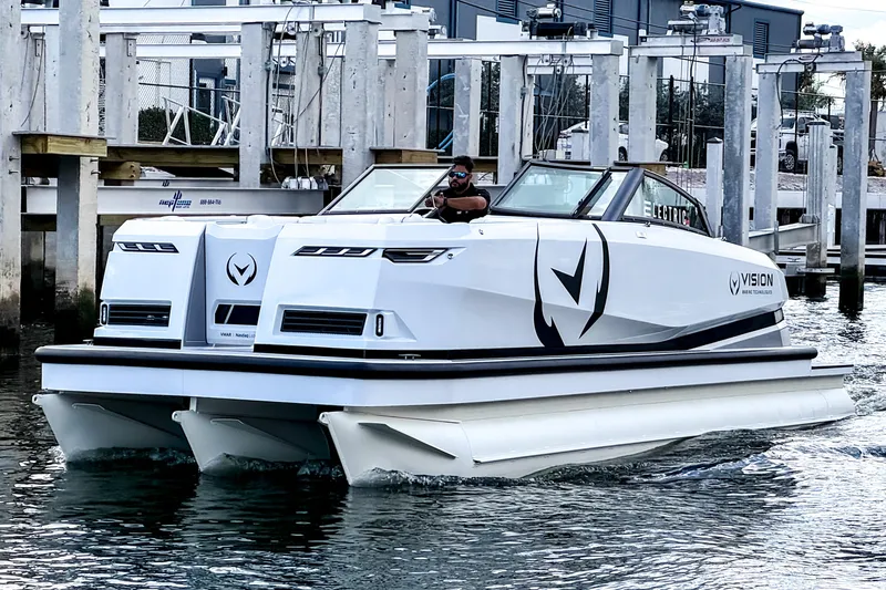  Yacht Photos Pics 2026 Ingenity EL electric boat cruising near a marina dock.