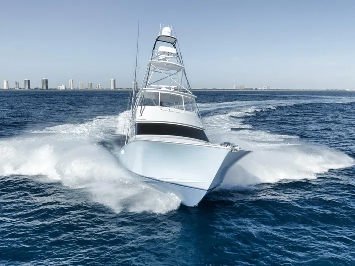 Big Fish II Yacht Photos Pics 2005 Viking Convertible yacht cruising swiftly on open ocean waters.