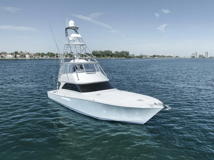 Big Fish II Yacht Photos Pics 2005 Viking Convertible yacht on calm blue waters, clear sky in the background.