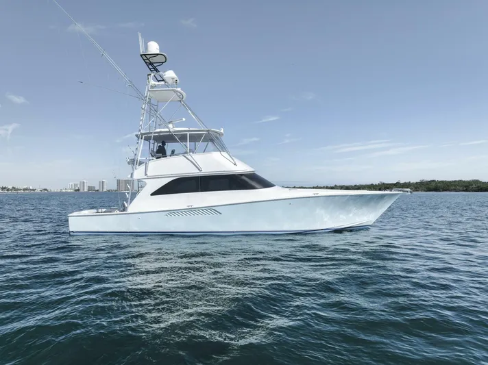 Big Fish II Yacht Photos Pics 2005 Viking Convertible yacht cruising on calm blue waters under a clear sky.