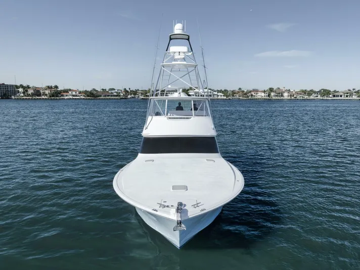 Big Fish II Yacht Photos Pics 2005 Viking Convertible yacht on calm water, front view, clear sky background.