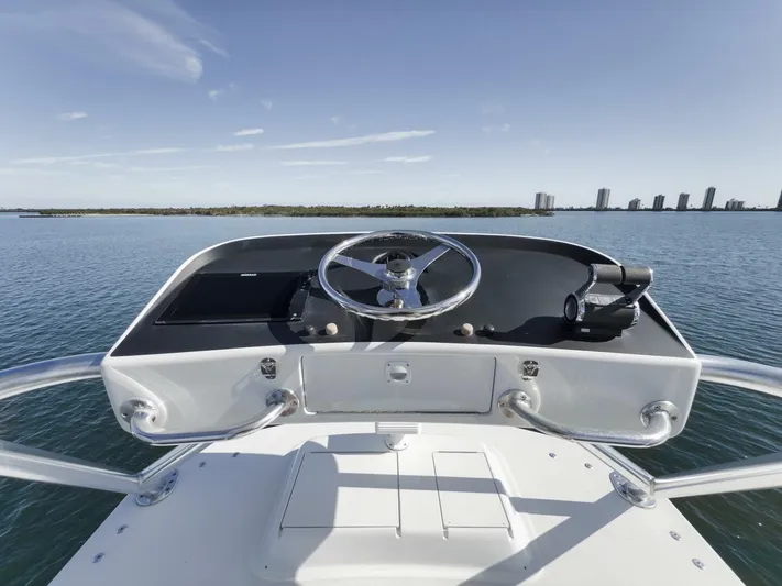 Big Fish II Yacht Photos Pics 2005 Viking Convertible boat helm with ocean view and city skyline in the background.