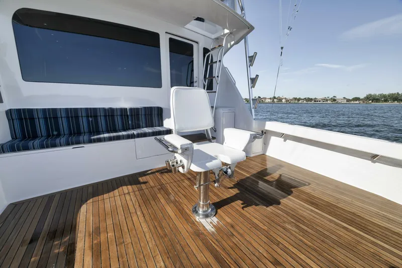Big Fish II Yacht Photos Pics 2005 Viking Convertible boat deck with fishing chair and seating, overlooking calm waters.