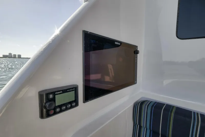 Big Fish II Yacht Photos Pics 2005 Viking Convertible boat interior with control panel and striped seating.