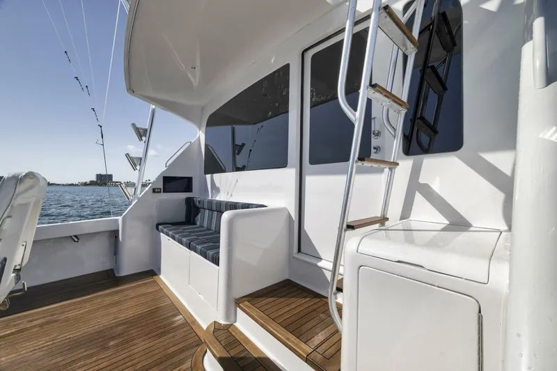 Big Fish II Yacht Photos Pics 2005 Viking Convertible yacht deck with seating, ladder, and ocean view.