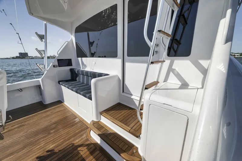 Big Fish II Yacht Photos Pics 2005 Viking Convertible yacht deck with seating and wooden flooring.