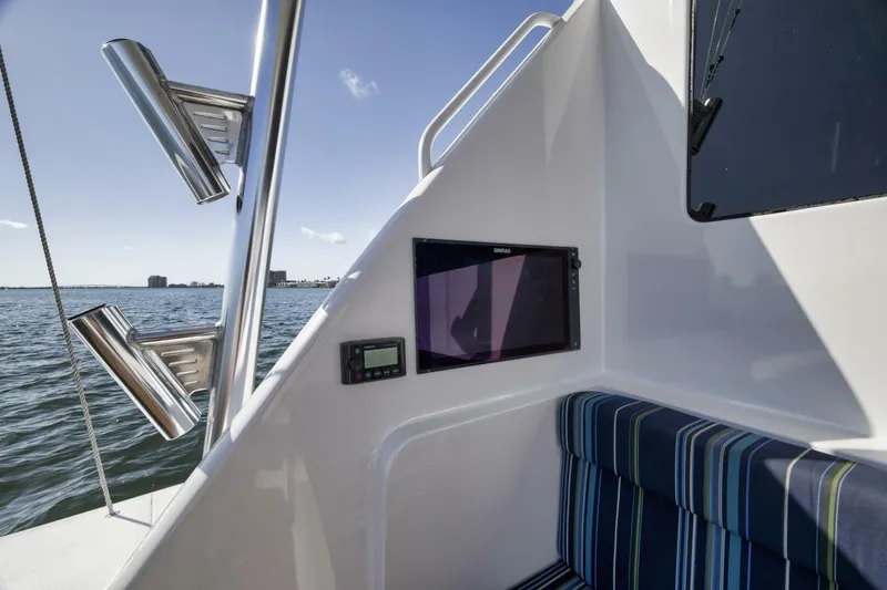 Big Fish II Yacht Photos Pics 2005 Viking Convertible boat interior with striped seating and ocean view.