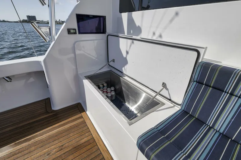 Big Fish II Yacht Photos Pics 2005 Viking Convertible boat with built-in cooler and striped seating on deck.