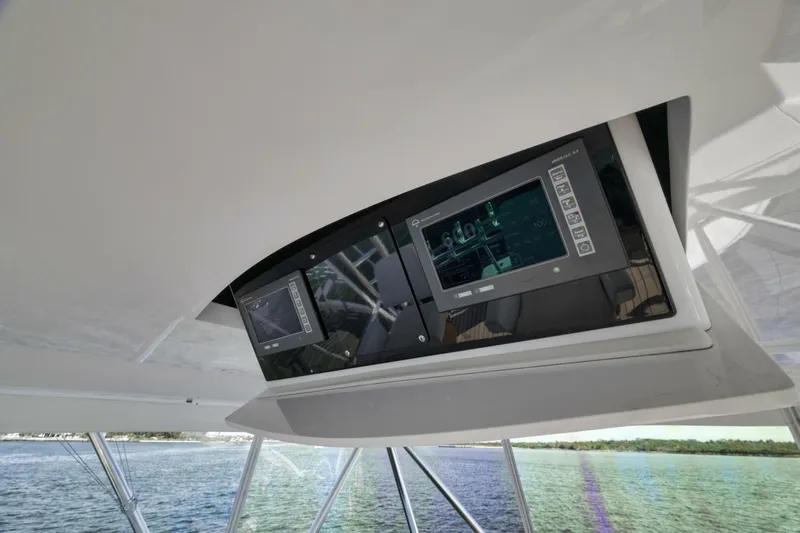 Big Fish II Yacht Photos Pics 2005 Viking Convertible yacht dashboard with advanced navigation screens on open water.