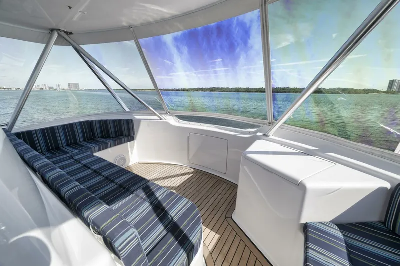 Big Fish II Yacht Photos Pics 2005 Viking Convertible yacht interior with striped seating, panoramic windows, and ocean view.