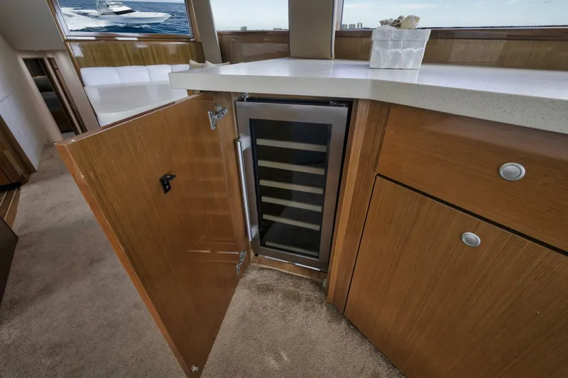 Big Fish II Yacht Photos Pics 2005 Viking Convertible yacht interior with open cabinet and built-in wine cooler.
