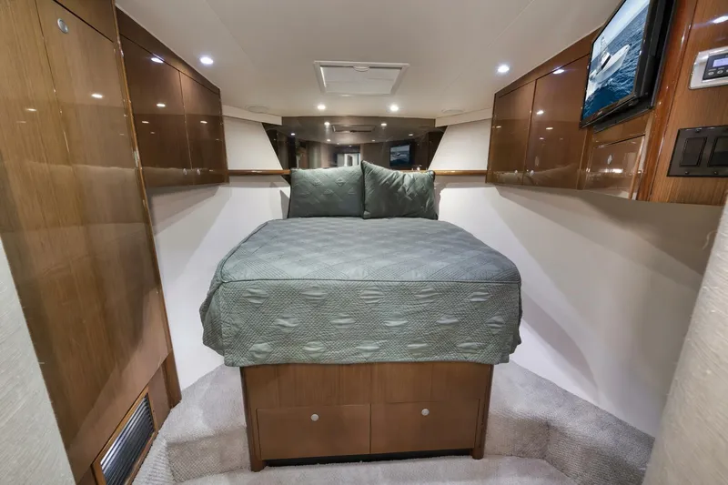 Big Fish II Yacht Photos Pics Luxurious cabin interior of a 2005 Viking Convertible yacht with a cozy bed.