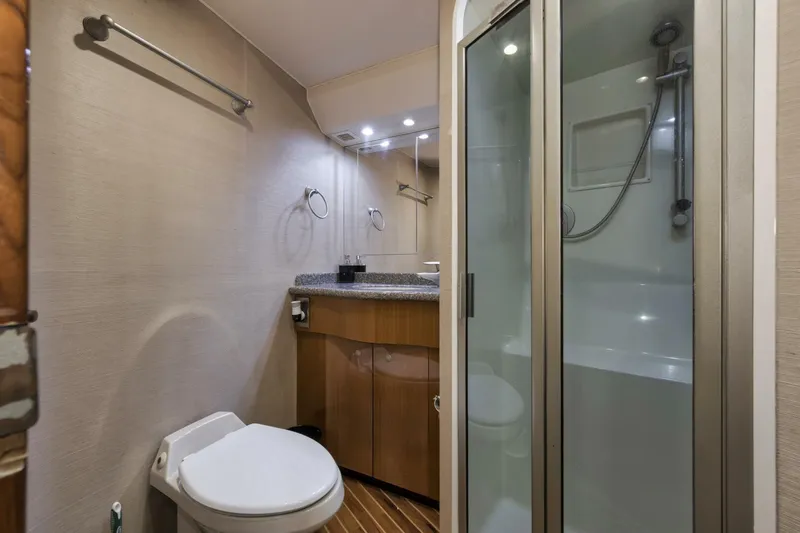 Big Fish II Yacht Photos Pics 2005 Viking Convertible yacht bathroom with shower, toilet, and vanity.