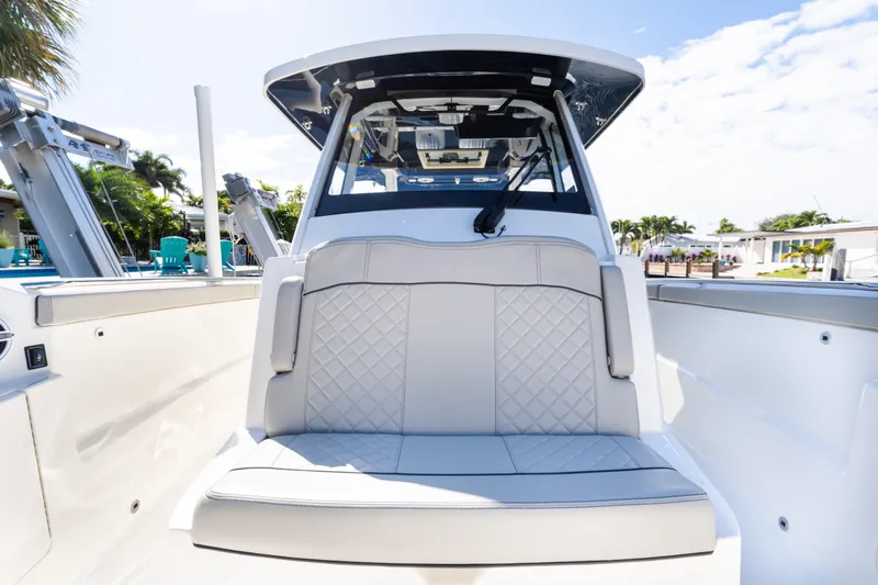  Yacht Photos Pics 2023 Pursuit S 328 Sport boat interior with cushioned seating and modern design.