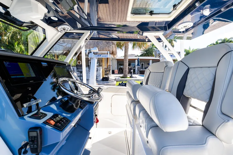  Yacht Photos Pics 2023 Pursuit S 328 Sport boat interior with modern helm and luxurious seating.