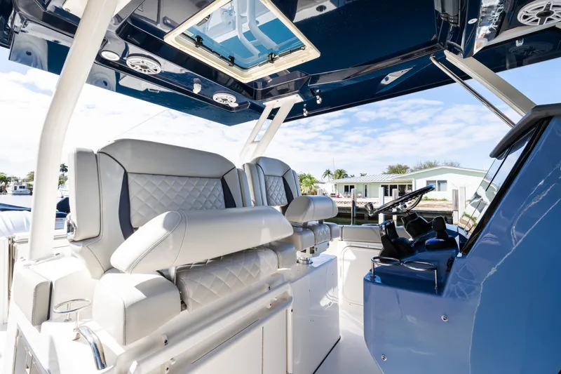  Yacht Photos Pics 2023 Pursuit S 328 Sport boat interior with luxurious seating and modern helm.