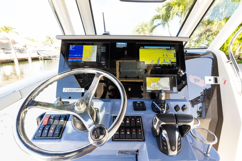  Yacht Photos Pics 2023 Pursuit S 328 Sport boat dashboard with advanced navigation displays and controls.
