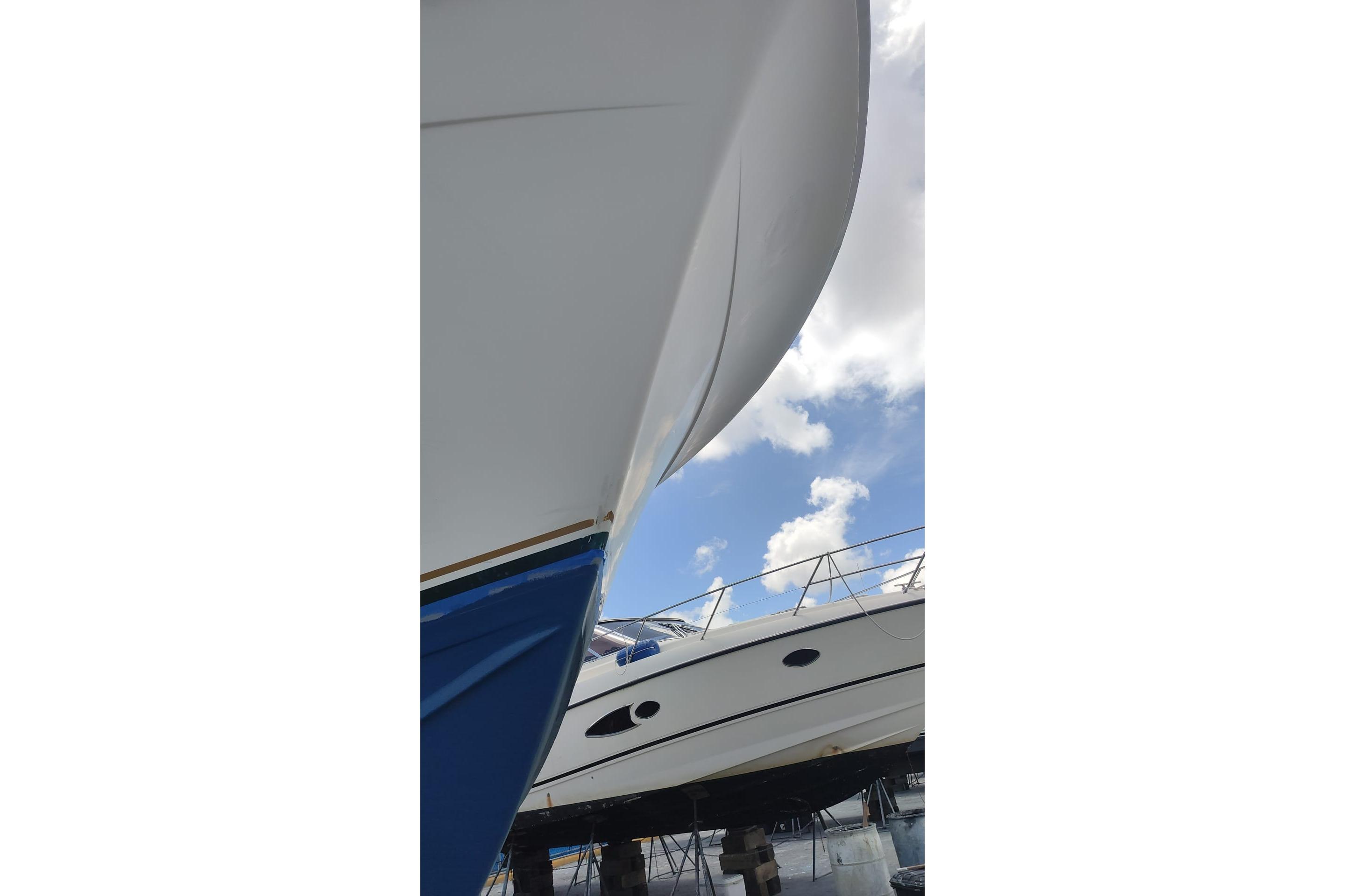 1977 Bertram 46 Convertible yacht, close-up view, under a clear blue sky.
