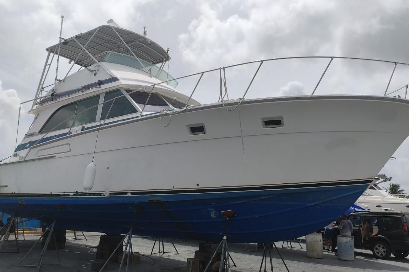 1977 Bertram 46 Convertible yacht on dry dock, showcasing its classic design and structure.
