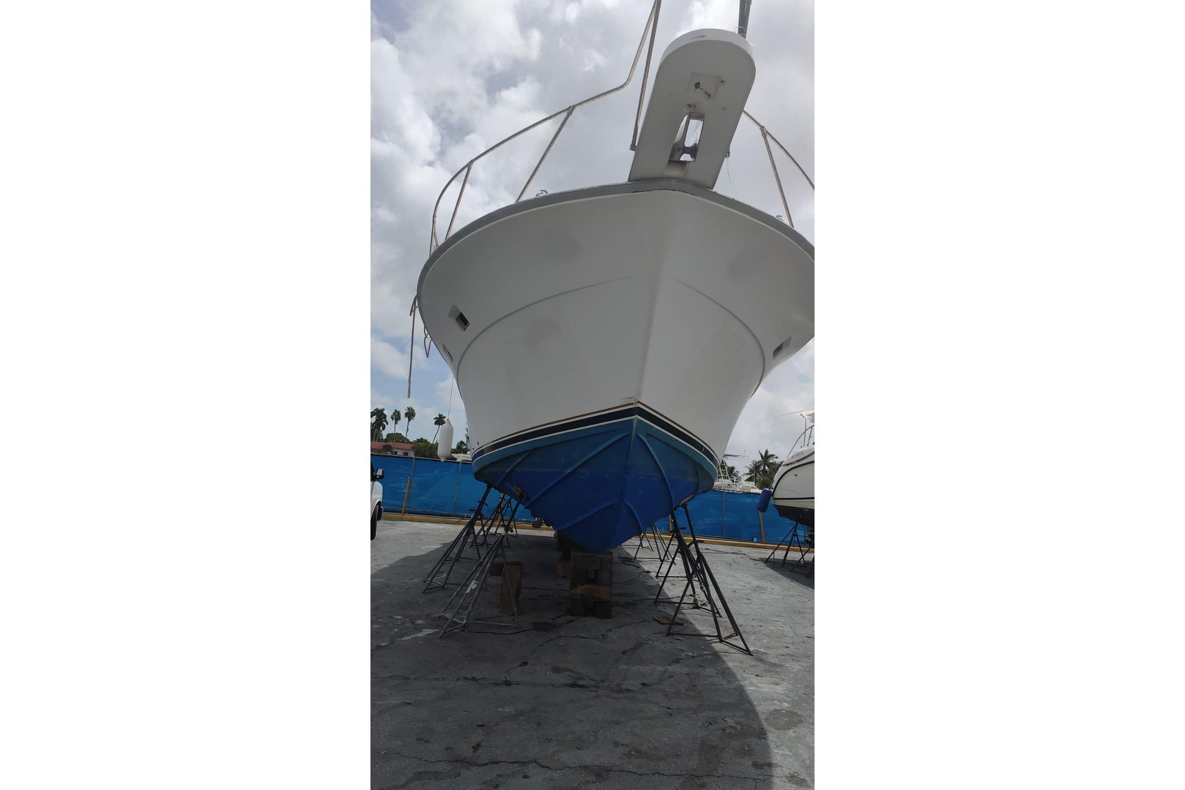 1977 Bertram 46 Convertible boat on dry dock, viewed from the front.
