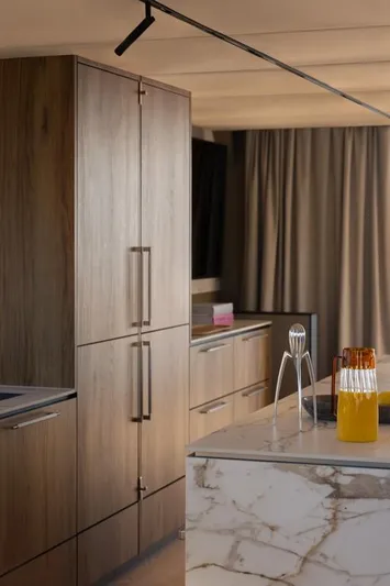 Full Moon Yacht Photos Pics Modern yacht kitchen with wooden cabinets, marble countertop, and orange juice pitcher. Moon 60 Sail 2024.