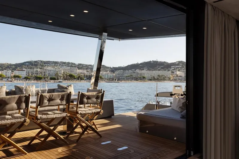 Full Moon Yacht Photos Pics Luxurious 2024 Moon 60 Sail yacht deck with scenic coastal view.